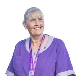 Heather Faulds smiling in a purple Hamill Homecare uniform and lanyard.