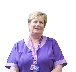 Heather Faulds in a purple Hamill Homecare uniform and lanyard, hands resting at her waist.